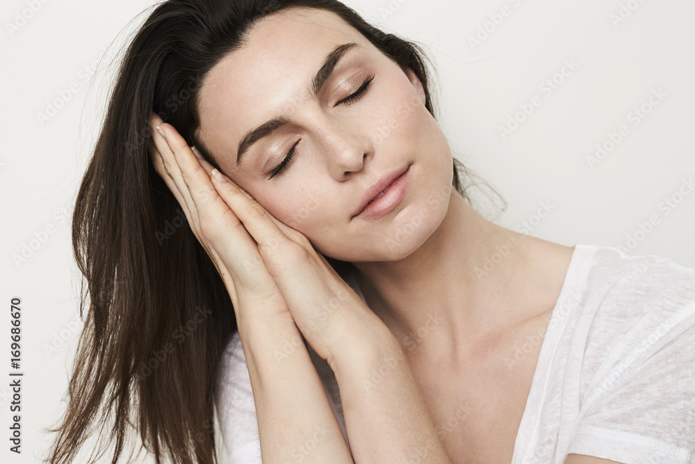 Sleeping brunette beauty resting in studio, eyes closed Sleeping brunette beauty resting in studio, eyes closed