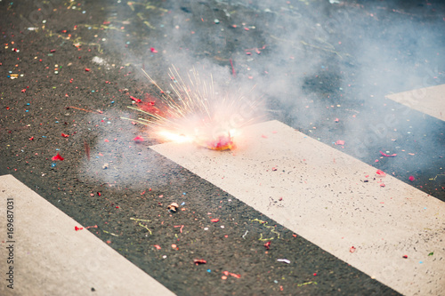 Firecracker exploding on the asphalt of a street, Paris, France