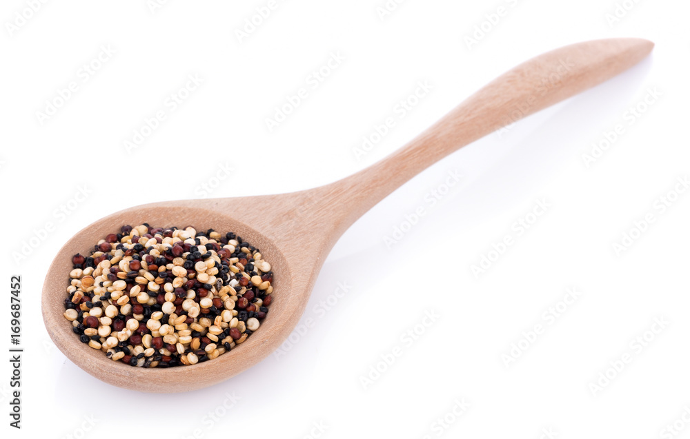 Real quinoa seeds in a wooden spoon isolated on white Real quinoa seeds in a wooden spoon isolated on white