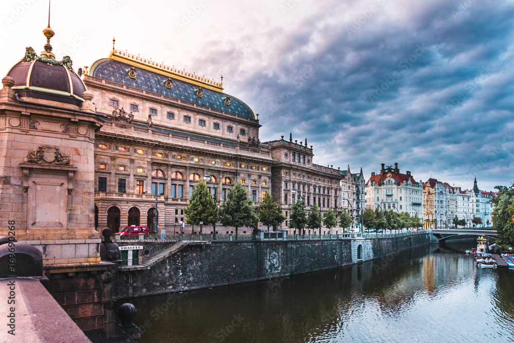 Prague National Theatre with golden roof and dramatic sky