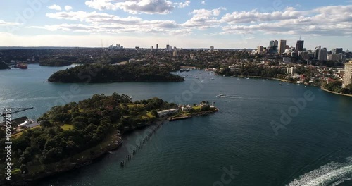 From mid harbour Goat island with ferry whart towards North Shore Berry bay and elevated cityscape of city of Sydney.
 photo