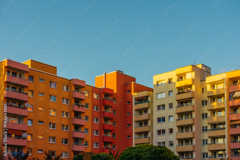 red and yellow apartment buildings with copy space in the sky