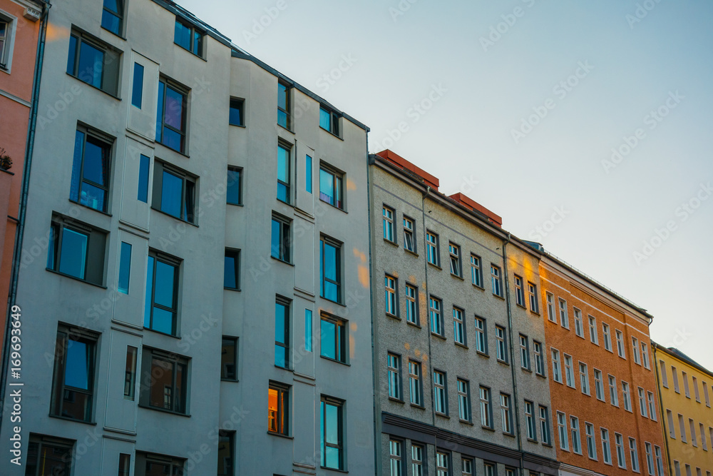 white and orange buildings in a row in the eve