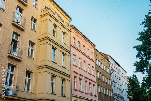 brown  yellow and pink houses in a row