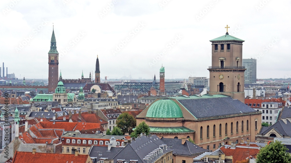Church of Our Lady and cityscape, aerial view from the platform at the top of the Rundetaarn or Round Tower in old town, cloudy weather, Copenhagen, Denmark