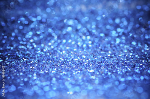 defocus of glitter vintage lights background. blue,white and black for Christmas and new year background.