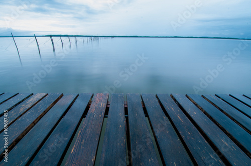 wooden pier and sea in morning of rainy day.