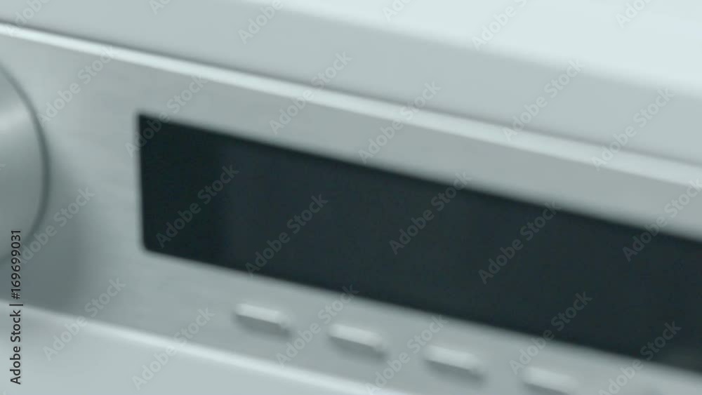 Someone is turning on a dishwasher to check if it is working properly. Someone is turning on a dishwasher to check if it is working properly.