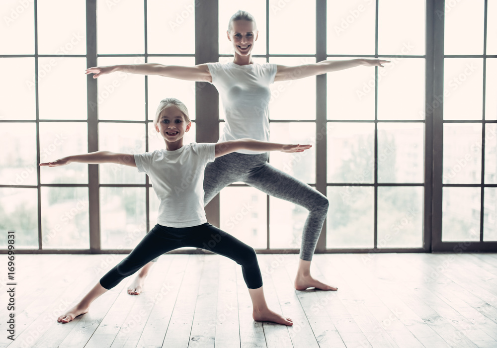 Mom with daughter working out at home Mom with daughter working out at home