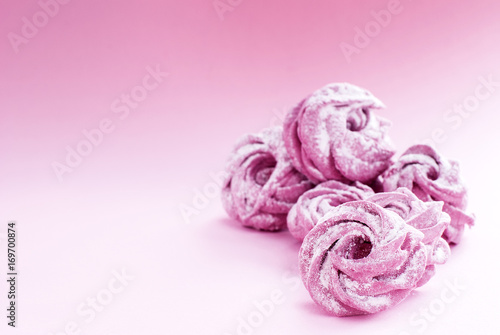 delicate pink marshmallow in powdered sugar, on a pink background