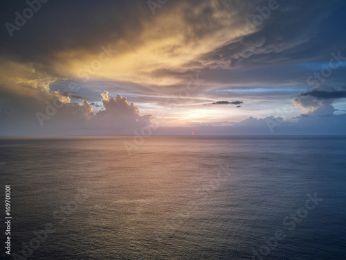 Sunset over calm ocean water © PixieMe