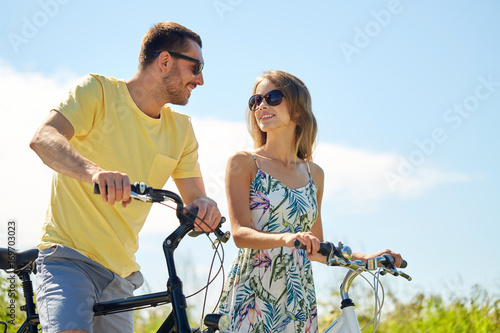 happy couple with bicycles at country