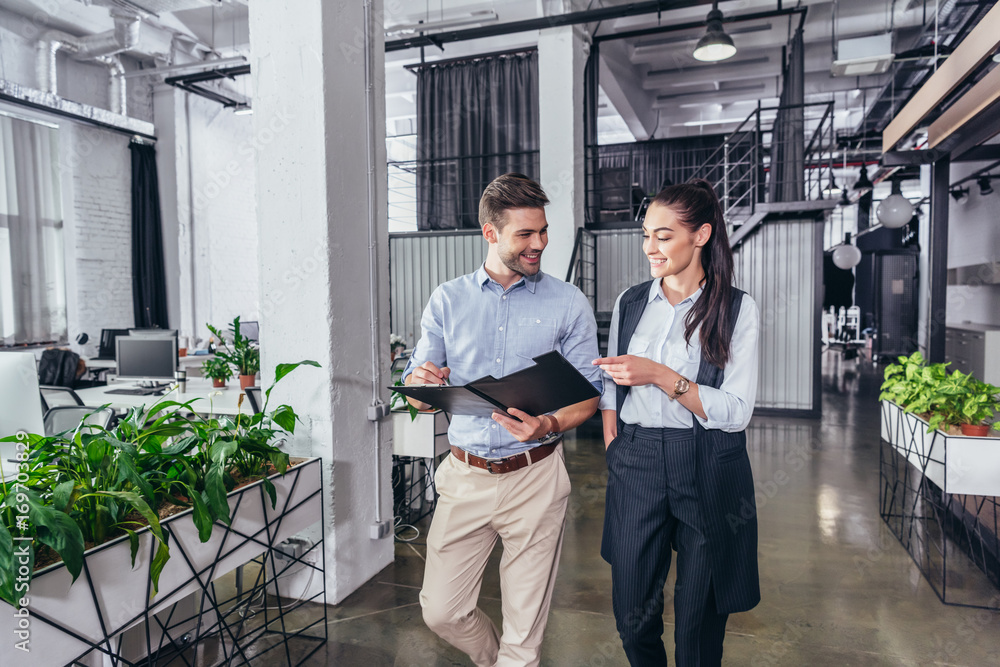 businessman and businesswoman with folder businessman and businesswoman with folder