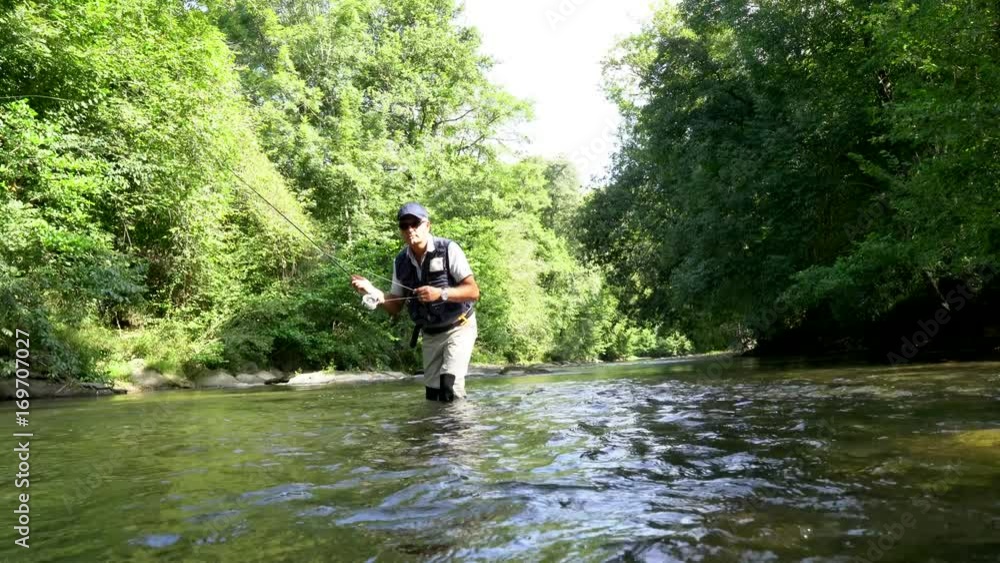Fly fisherman fishing in French river Fly fisherman fishing in French river