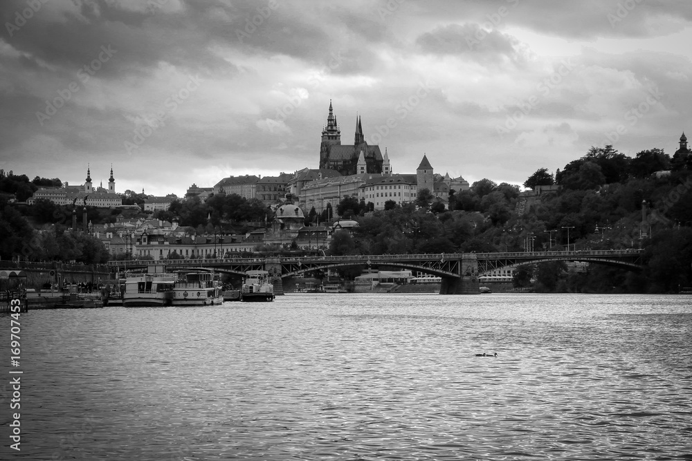 Fototapeta premium Prague castle in black and white at sunset, seen from a cruise on the Vltava river in Prague city center