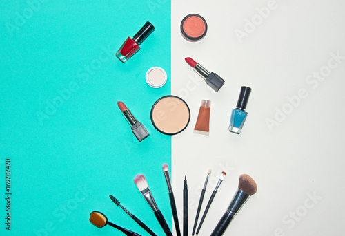 Cosmetics white and blue background with make up artist objects: lipstick, eye shadows, mascara ,eyeliner, concealer, nail polish. Lifestyle Concept
