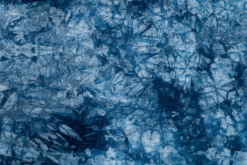 Pattern of blue dye on cotton cloth, Dyed indigo fabric background and textured