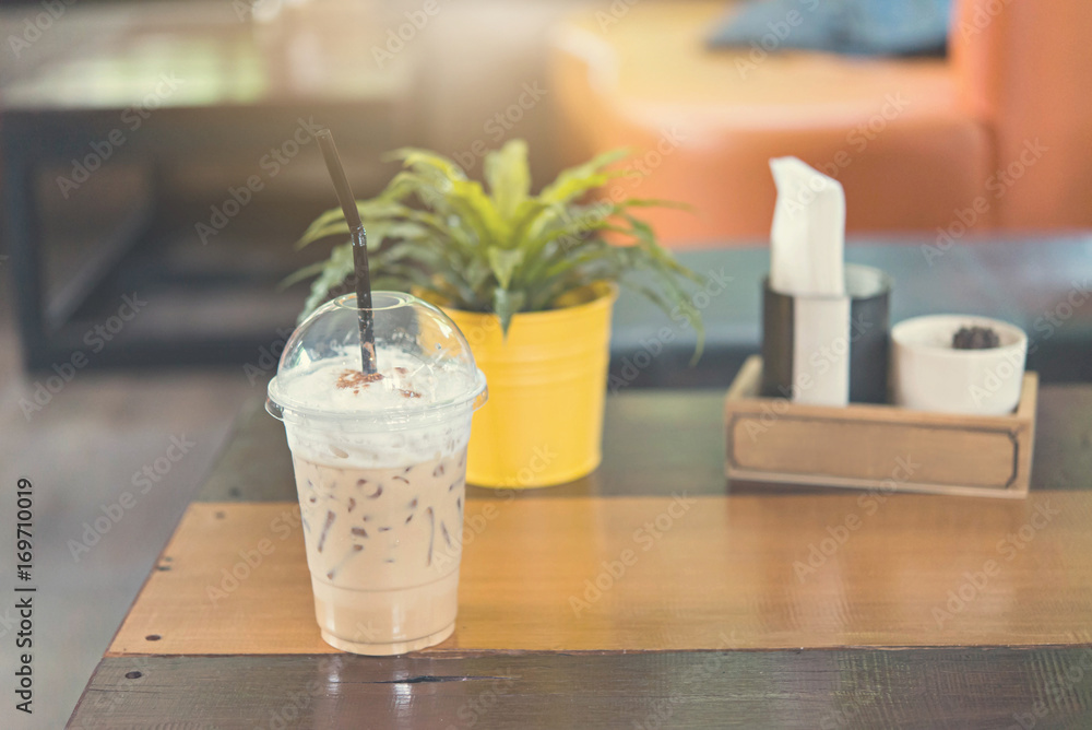 Latte iced coffee on wood table in coffee shop. Latte iced coffee on wood table in coffee shop.