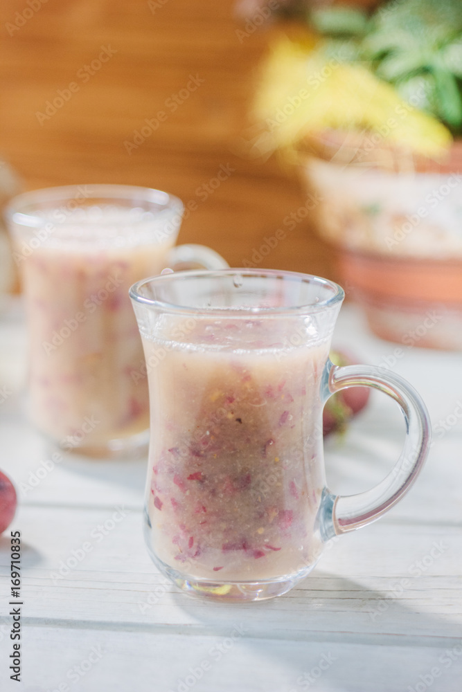Grape smoothie over the white table. Grape smoothie over the white table.