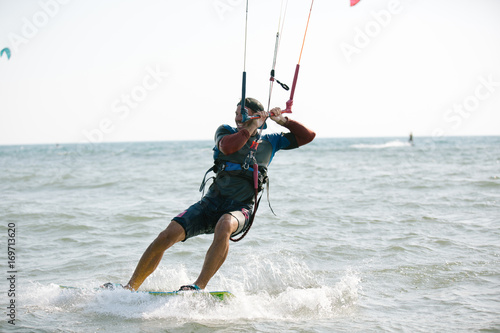Kitesurfing, Kiteboarding action photos, man among waves quickly goes