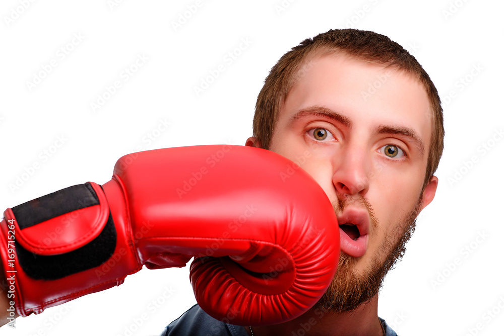 A young sports man-boxer poses to the camera. Man got a punch to the face by red boxing glove