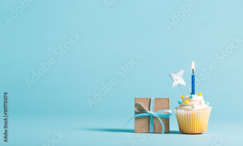 Cupcake with candle and present box celebration theme