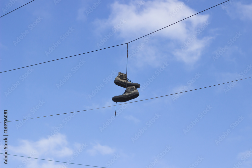 Shoes hanging from telephone wire Stock Photo | Adobe Stock