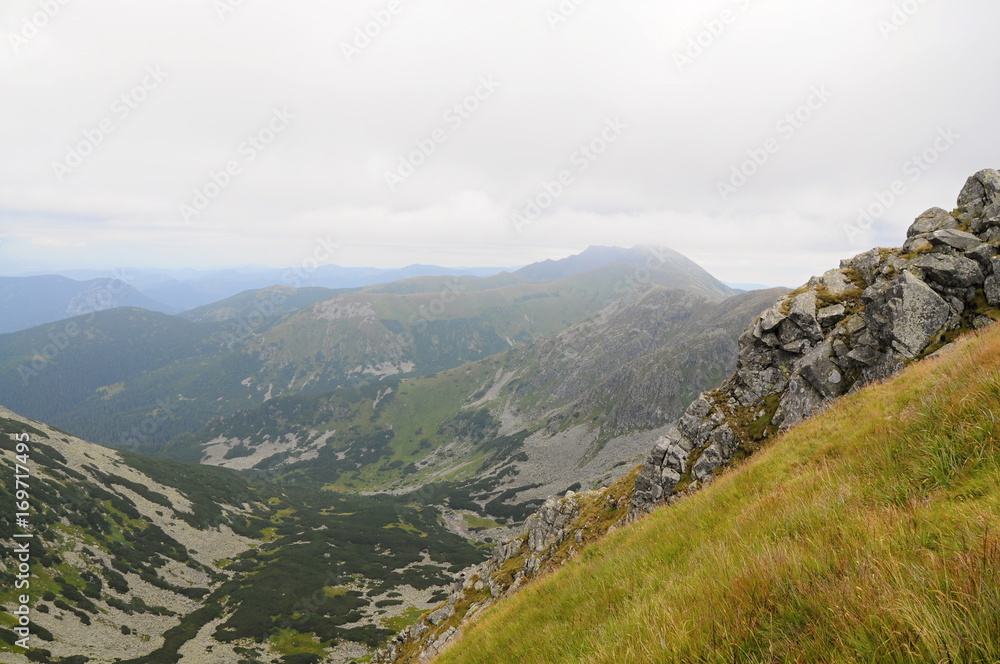 Tatra mountains landscape panorama with green grass and white clouds. Slovakia national park.