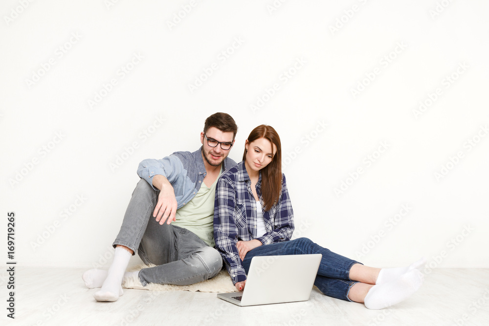 Couple discuss design project for home interior Couple discuss design project for home interior