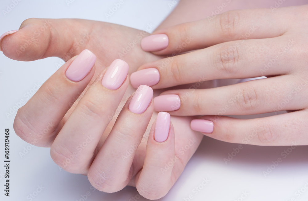 Amazing natural nails. Women's hands with clean manicure. Gel polish applied.