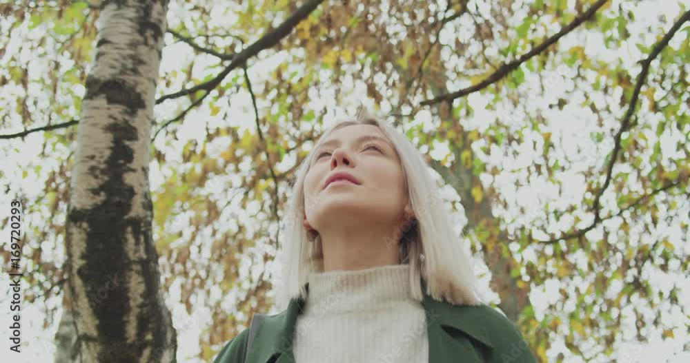 Detail on face. Caucasian blond woman slomo walking through fall woods.Following in front gimbal.Storytelling real young adult people alone in autumn forest.4k slow motion video Detail on face. Caucasian blond woman slomo walking through fall woods.Following in front gimbal.Storytelling real young adult people alone in autumn forest.4k slow motion video