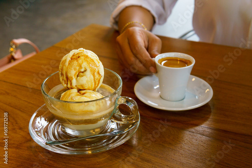 affogato with business women hand holding espresso coffee in white cup background.