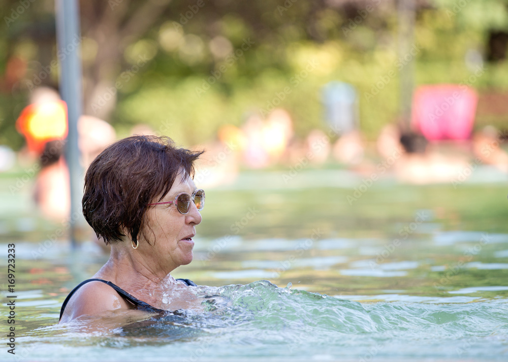 Old woman resting in pool