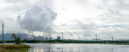 panorama view of coal fire power plant release steam to sky from stack tower. electricity, climate change and power plant concept.