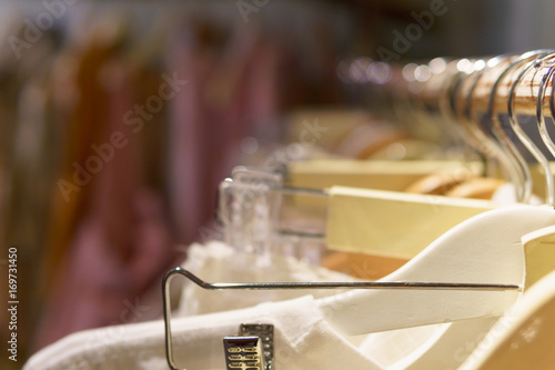 selective focus. clothes hanger on the bar with blurred background. copy space for text. decoration or fashions magazine concept