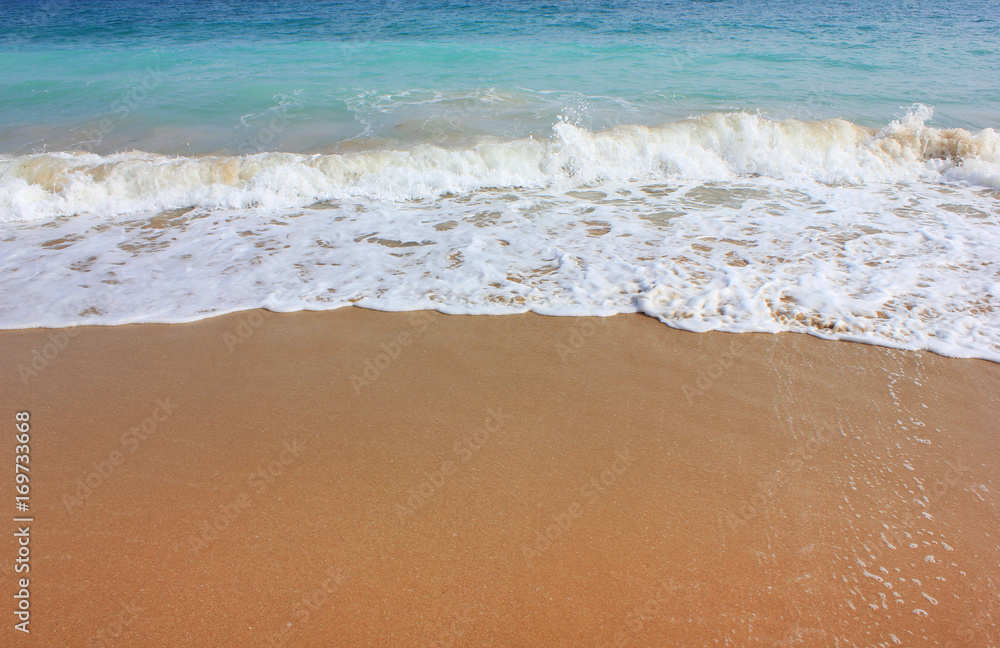 Beach shore with waves crushing on sand. Vivid summer season image, tropical vacation background. Sunny bright day light with clear blue water and empty copy space Travel tourism relax holiday concept Beach shore with waves crushing on sand. Vivid summer season image, tropical vacation background. Sunny bright day light with clear blue water and empty copy space Travel tourism relax holiday concept