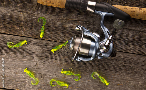 spinning rod  And bait on a wooden background