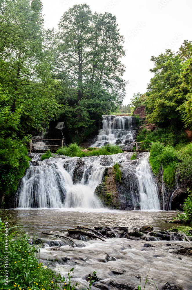 Obraz premium Cascaded waterfall in a green forest. Dzhurinsky waterfall Ukraine.