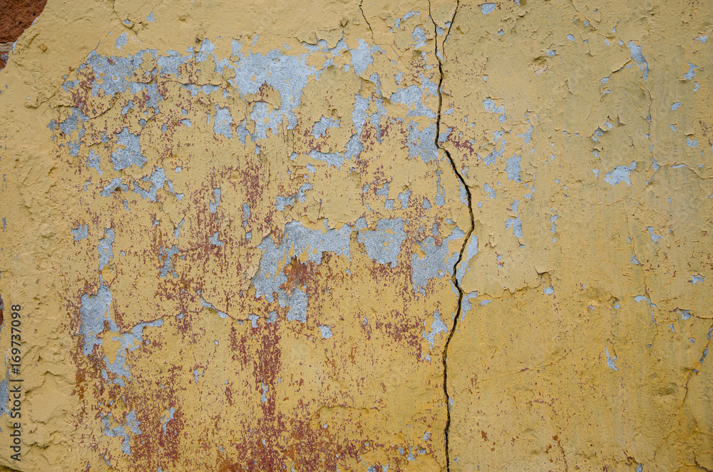 Abstract background of cracked yellow paint 