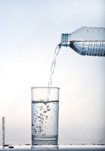 Wallpaper Mural pouring water on a glass on white background,Glass of water, Glass of water isolated on white background,Water pouring from bottle into the glass, isolated on white Torontodigital.ca