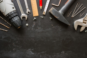 Old building tools on a black background with space for text