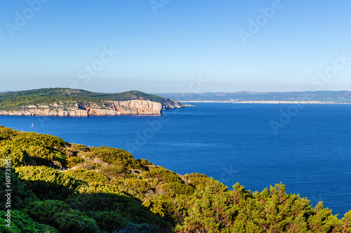 Sardinia, Italy. Coastal rocks. On the horizon, the city of Alghero © Valery Rokhin