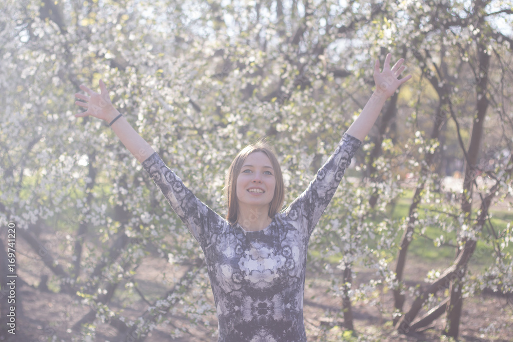 happy young woman in spring flowers happy young woman in spring flowers