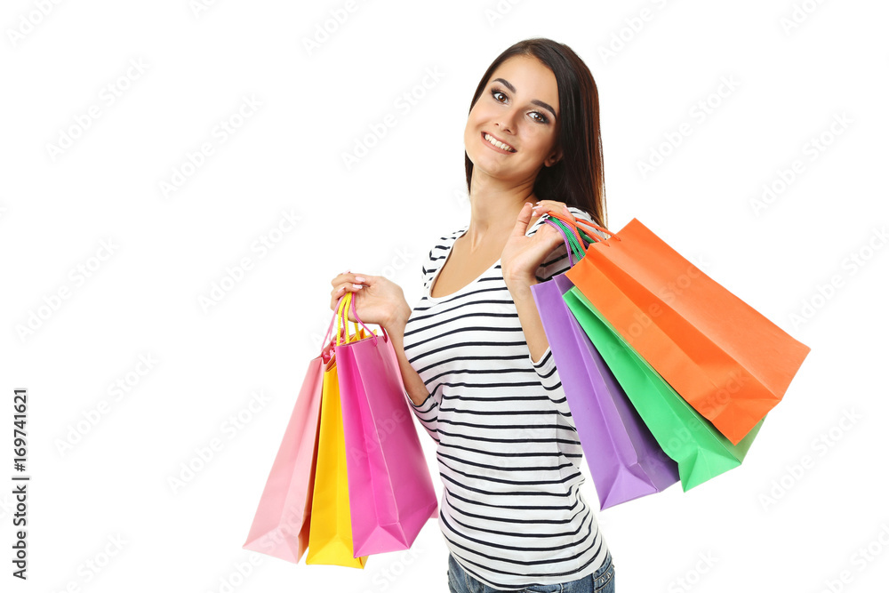 Portrait of young woman with shopping bags on white background
