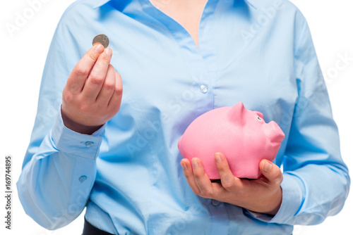 Close-up of businesswoman's hands with a pink piggy bank