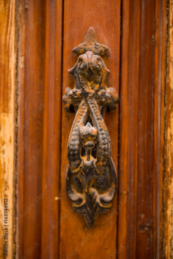 Rusty vintage door handle on a wooden door
