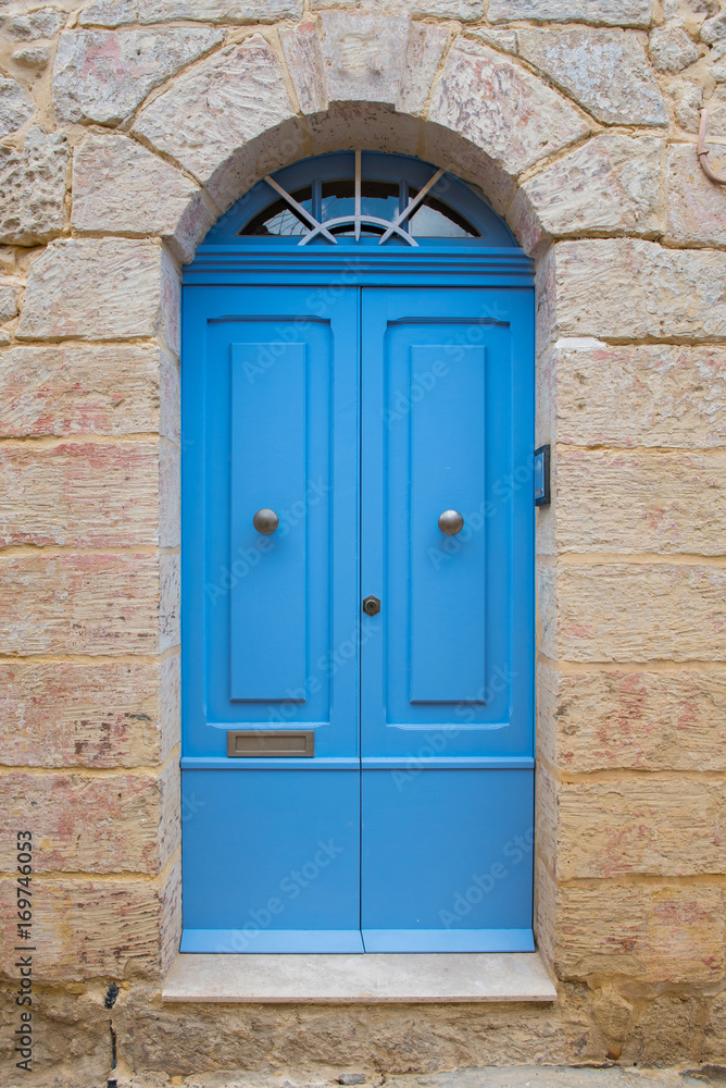 Traditional wooden painted blue door in Malta
