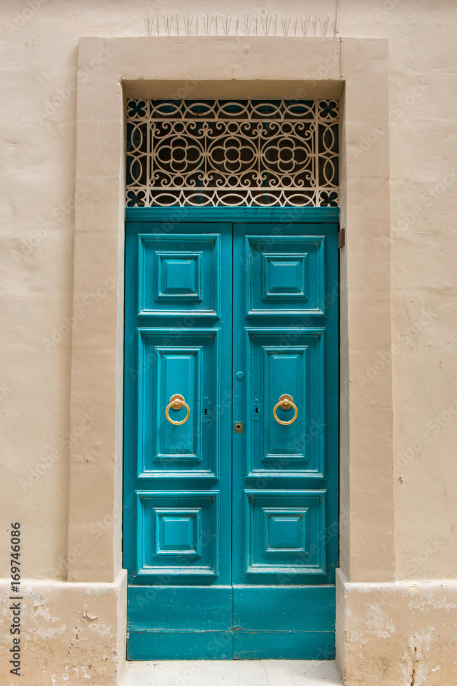 Naklejka premium Traditional wooden painted turquoise door in Malta