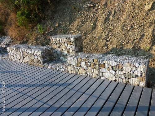Stones in metal wire cage - Steel mesh of gabion wall