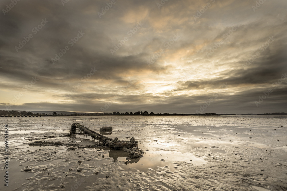 anchor beached in bay at dusk